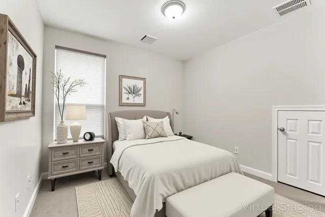 a bedroom with a bed and a night stand