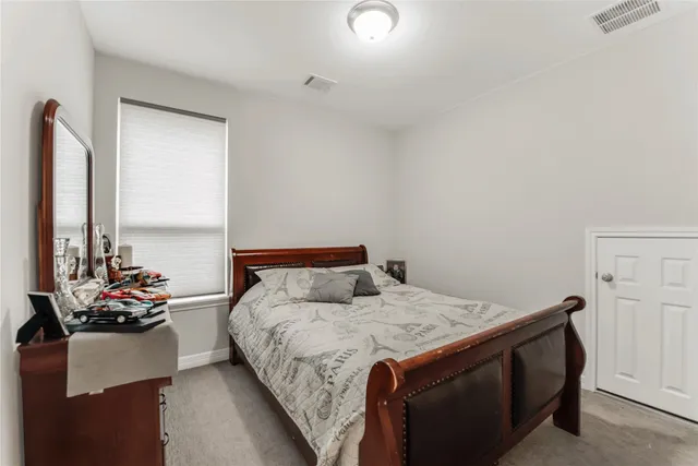 a bedroom with a bed and a dresser