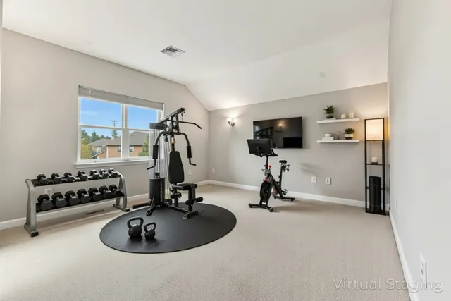 a bedroom with a bed window and a night stand