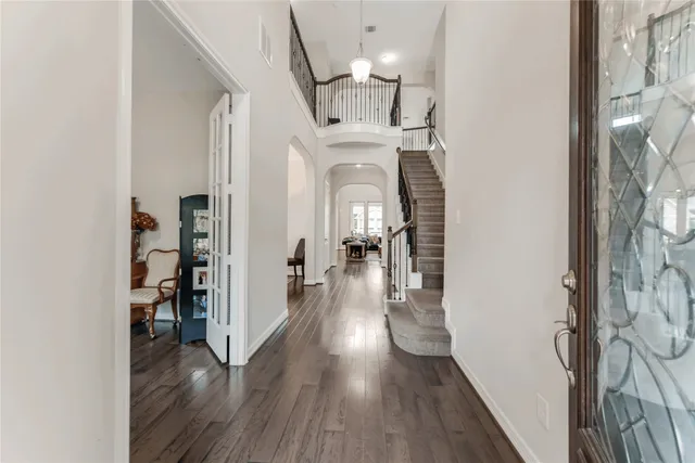 a view of a hallway with wooden floor windows and livingroom