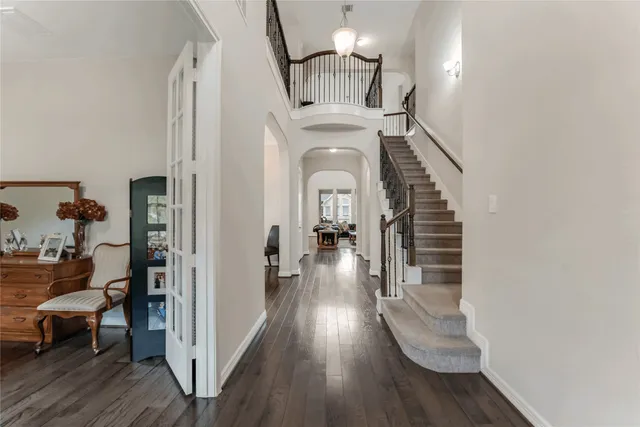 a view of a hallway with wooden floor fireplace and living room