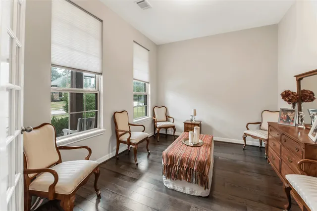 a living room with furniture and two windows