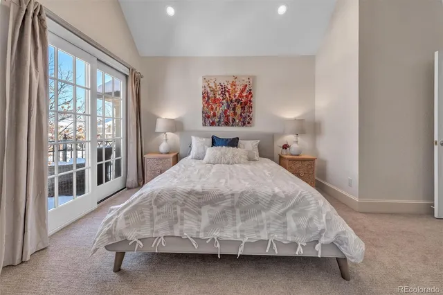 a bedroom with a large bed and a large window