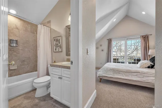 a bedroom with a bed and a couch