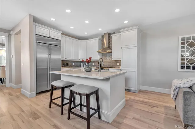 a kitchen with kitchen island a sink stove and refrigerator