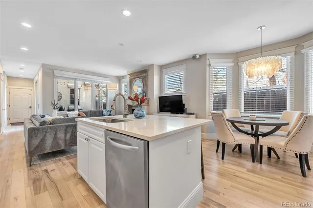 a kitchen with kitchen island a sink table and chairs