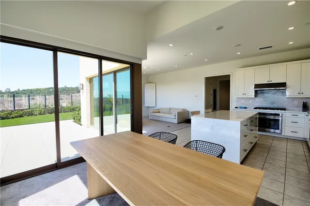 a living room with fireplace furniture and a large window