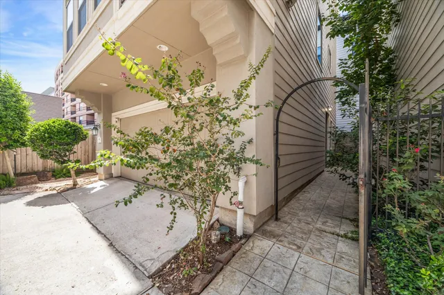 a view of a pathway of a house with wooden fence
