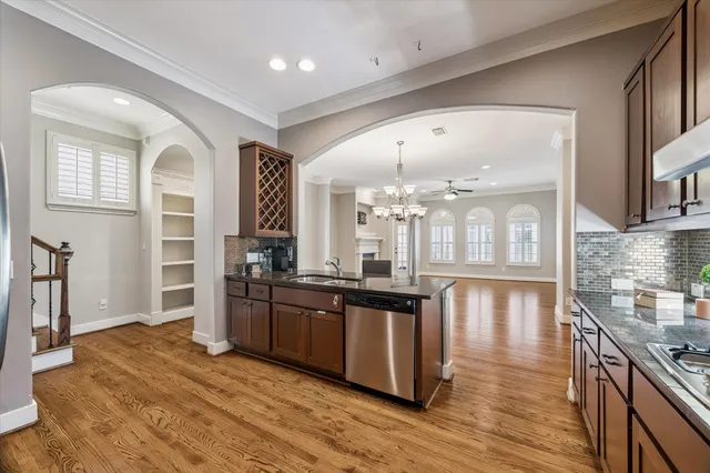 a kitchen with stainless steel appliances granite countertop a stove and a wooden floors