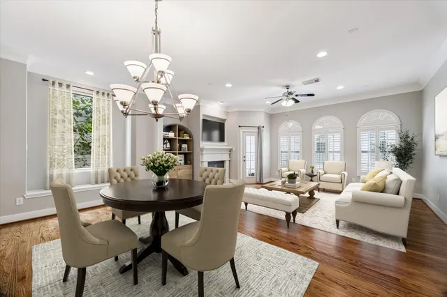 a living room with patio furniture and a chandelier