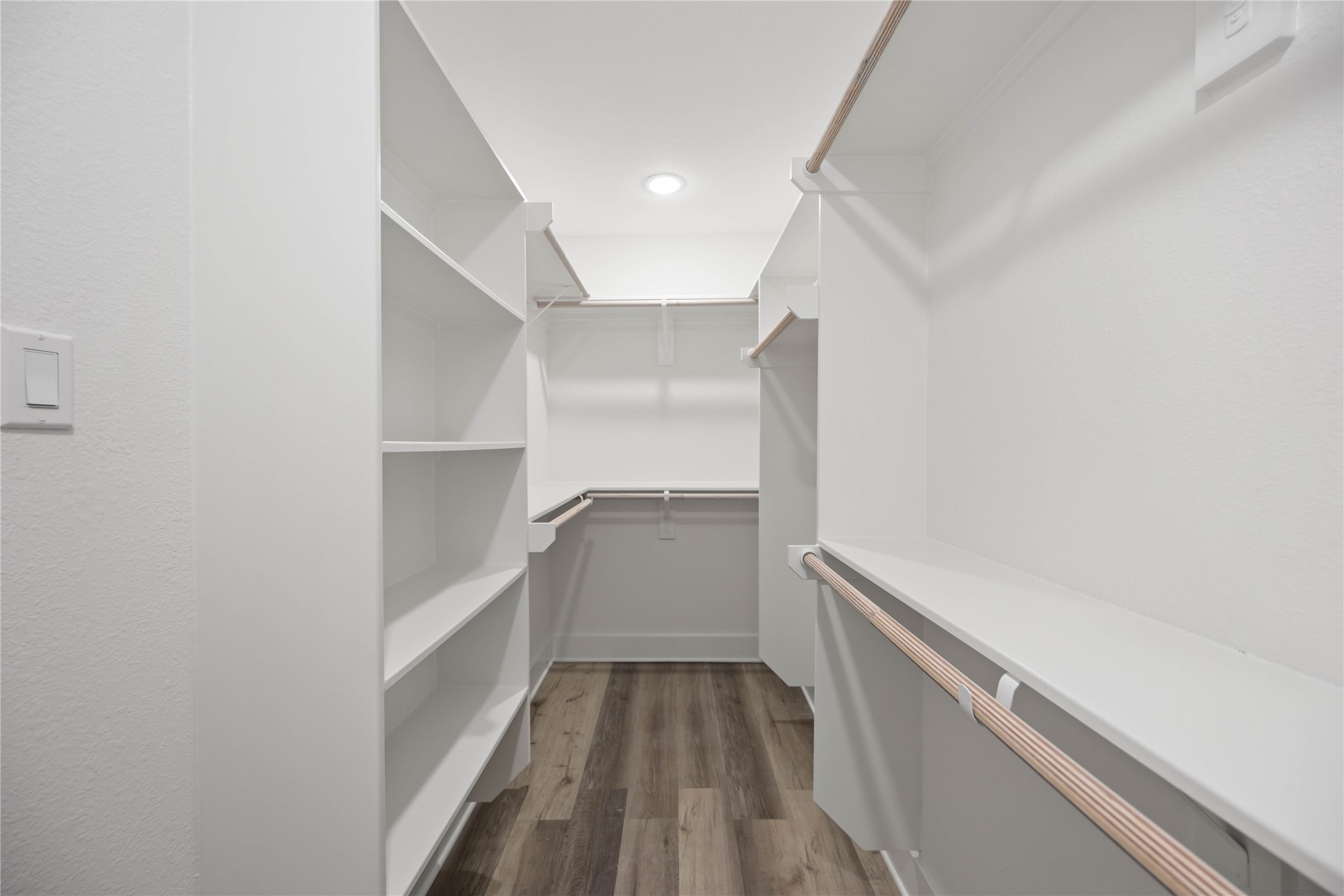 3405 Mt Pleasant Street Houston, TX 77021 - Photo 14 of 20 A spacious walk-in closet with plenty of shelving and hanging space, finished with a clean, modern design and luxury vinyl flooring.