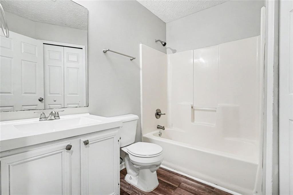 6221 Amberly Road Rex, GA 30273 - Photo 12 of 17 a bathroom with a toilet a sink a mirror a bathtub and vanity