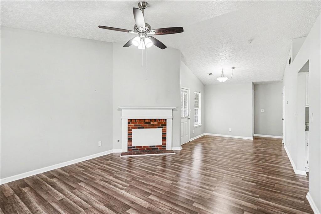 6221 Amberly Road Rex, GA 30273 - Photo 3 of 17 a view of an empty room with wooden floor and a ceiling fan