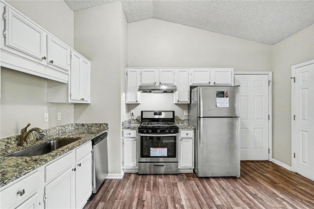 6221 Amberly Road Rex, GA 30273 - Photo 5 of 17 a kitchen with a refrigerator and a stove top oven