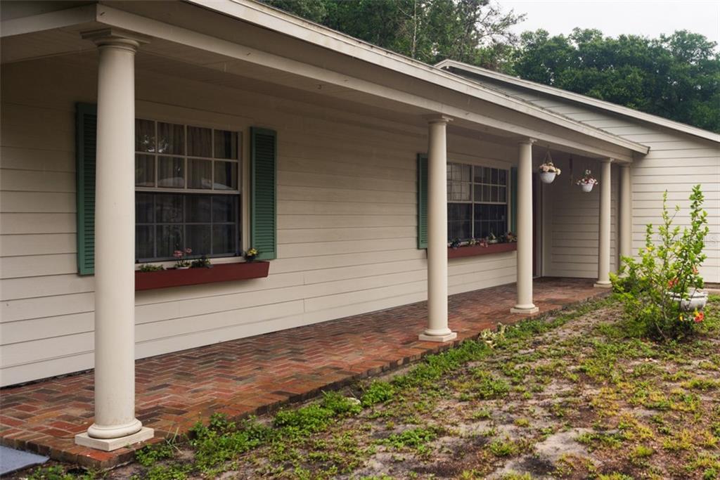 11638 Fox Run Port Richey, FL 34668 - Photo 1 of 1 Charming front porch with brick patio . Room for front porch living!