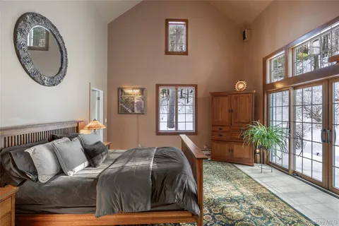a bed sitting in a bedroom next to a window
