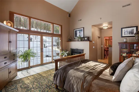 a bedroom with a large bed and a chandelier