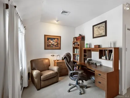 a view of a livingroom with workspace and a couch