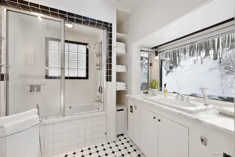 a bathroom with a bathtub sink vanity and mirror