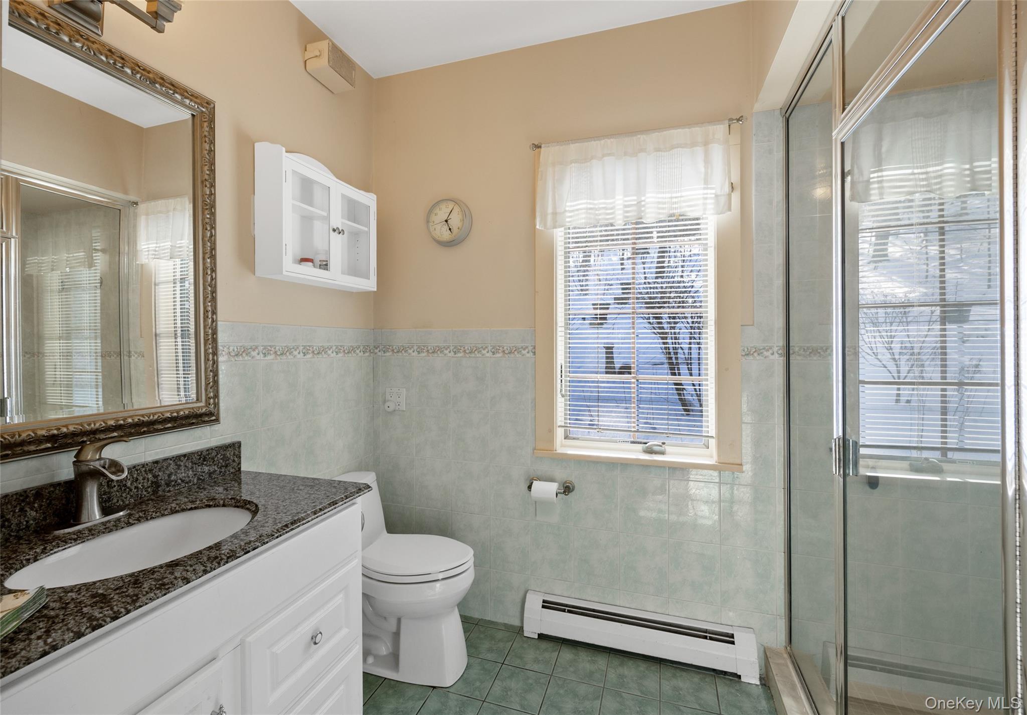 326 Pratt Hill Road Austerlitz, NY 12037 - Photo 21 of 31 a bathroom with a granite countertop toilet a sink and a mirror