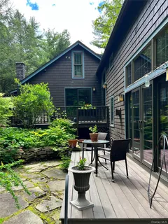 a view of a chairs and table in backyard of the house