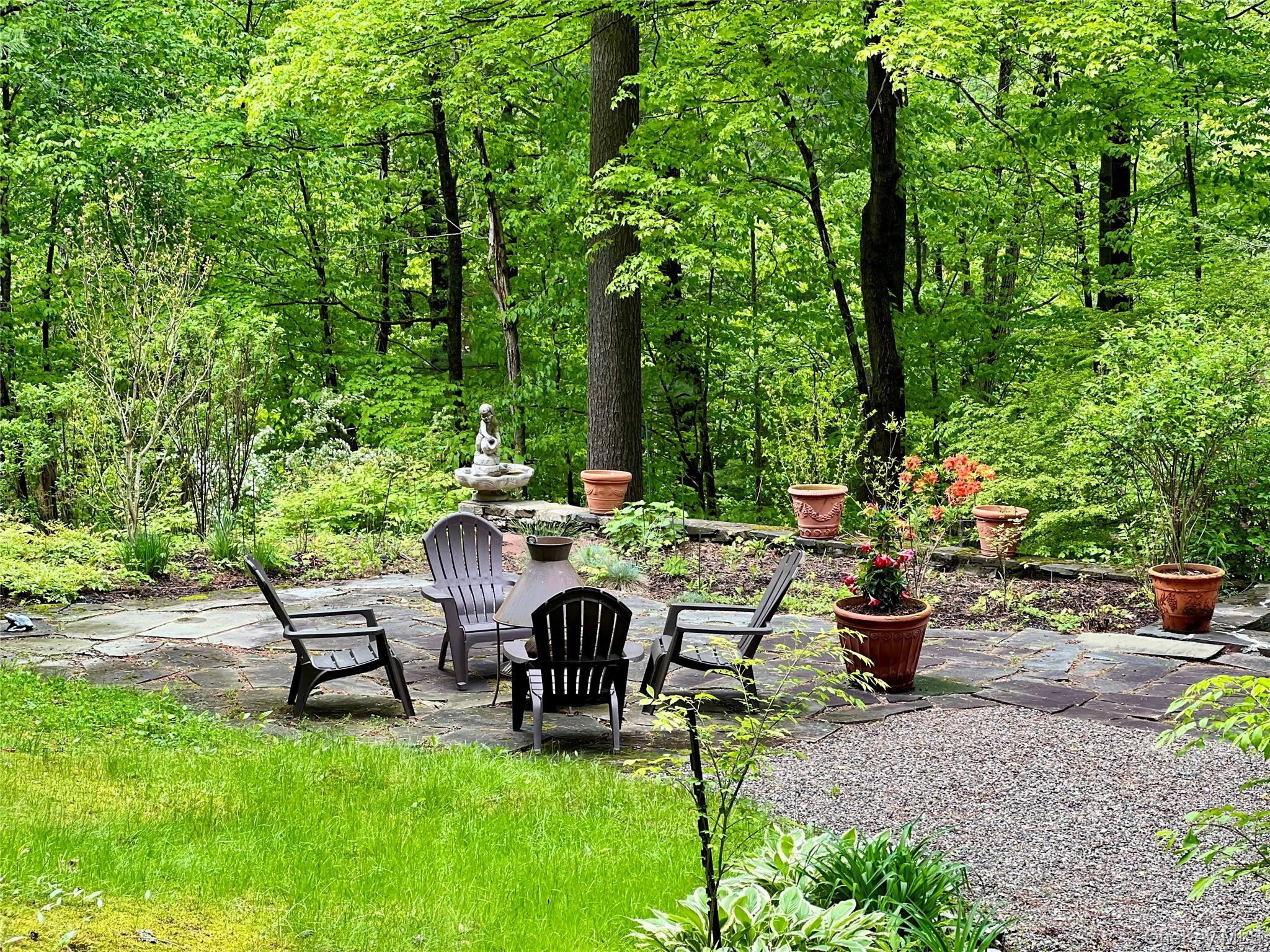 326 Pratt Hill Road Austerlitz, NY 12037 - Photo 25 of 31 a view of a patio with table and chairs potted plants and large tree