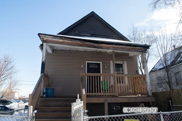 a front view of house with a garden