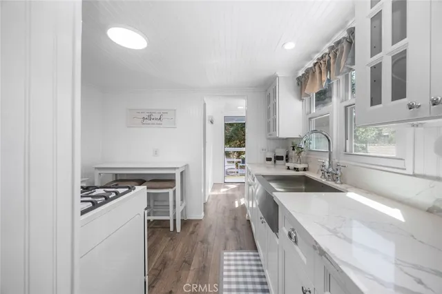 a kitchen that has a sink and a stove