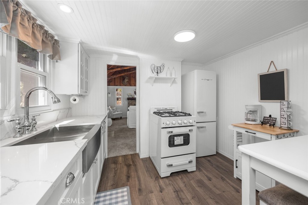 1177 Bear Springs Road Rimforest, CA 92378 - Photo 14 of 37 a kitchen with a sink stove and refrigerator