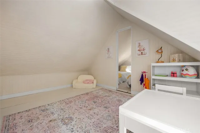 a view of a livingroom with furniture and staircase