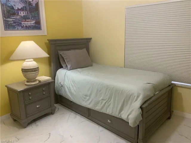 a bedroom with a bed and lamps