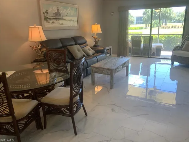 a living room with furniture and a lamp