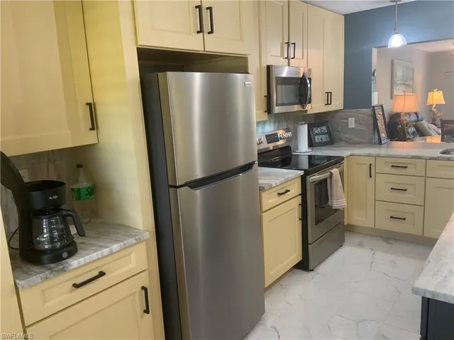 a kitchen with appliances cabinets and a counter top space