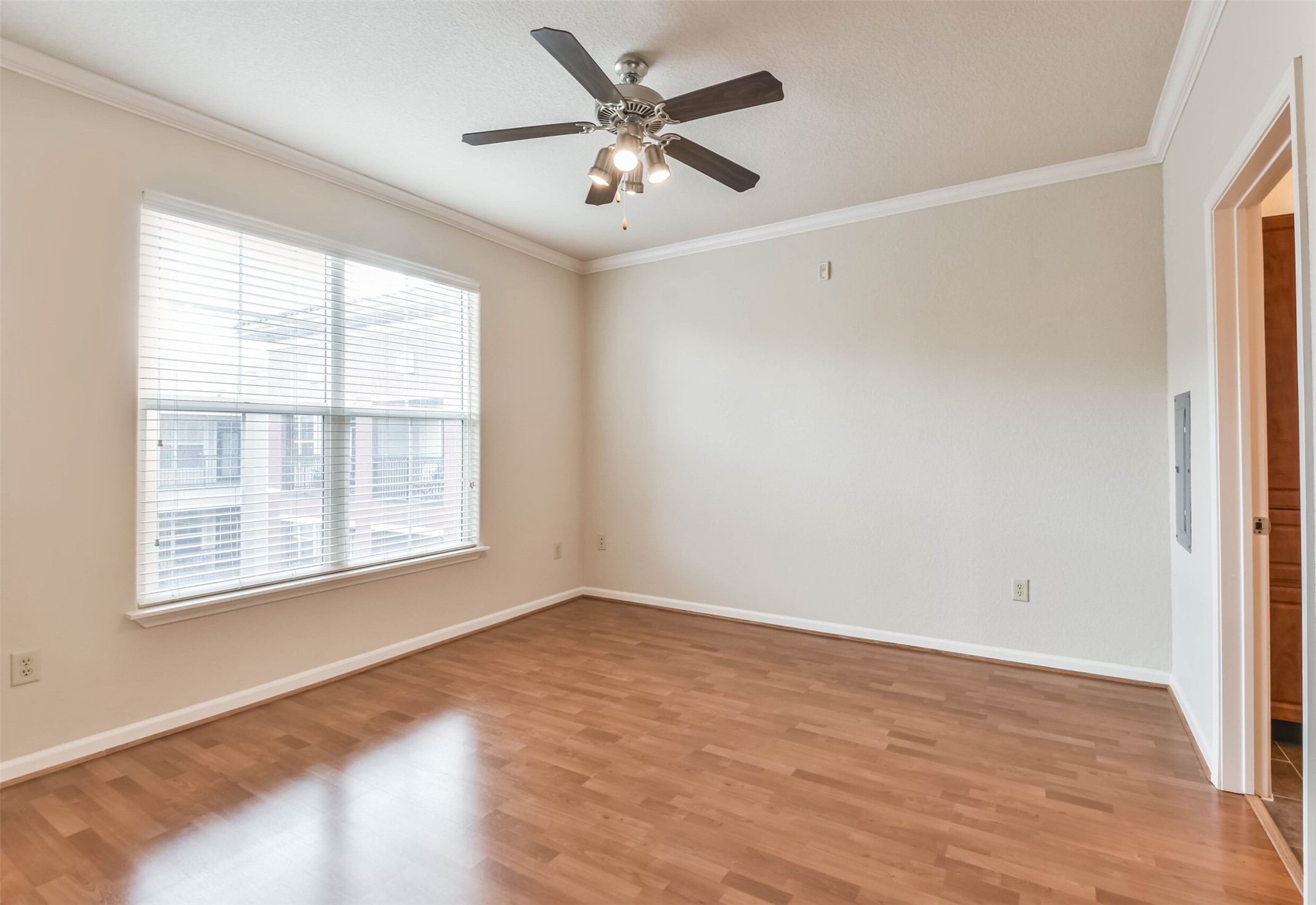 1711 Old Spanish Trail, Unit 406 Houston, TX 77054 - Photo 13 of 30 an empty room with wooden floor and windows
