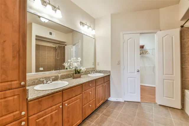 a spacious bathroom with a double vanity sink shower and a mirror