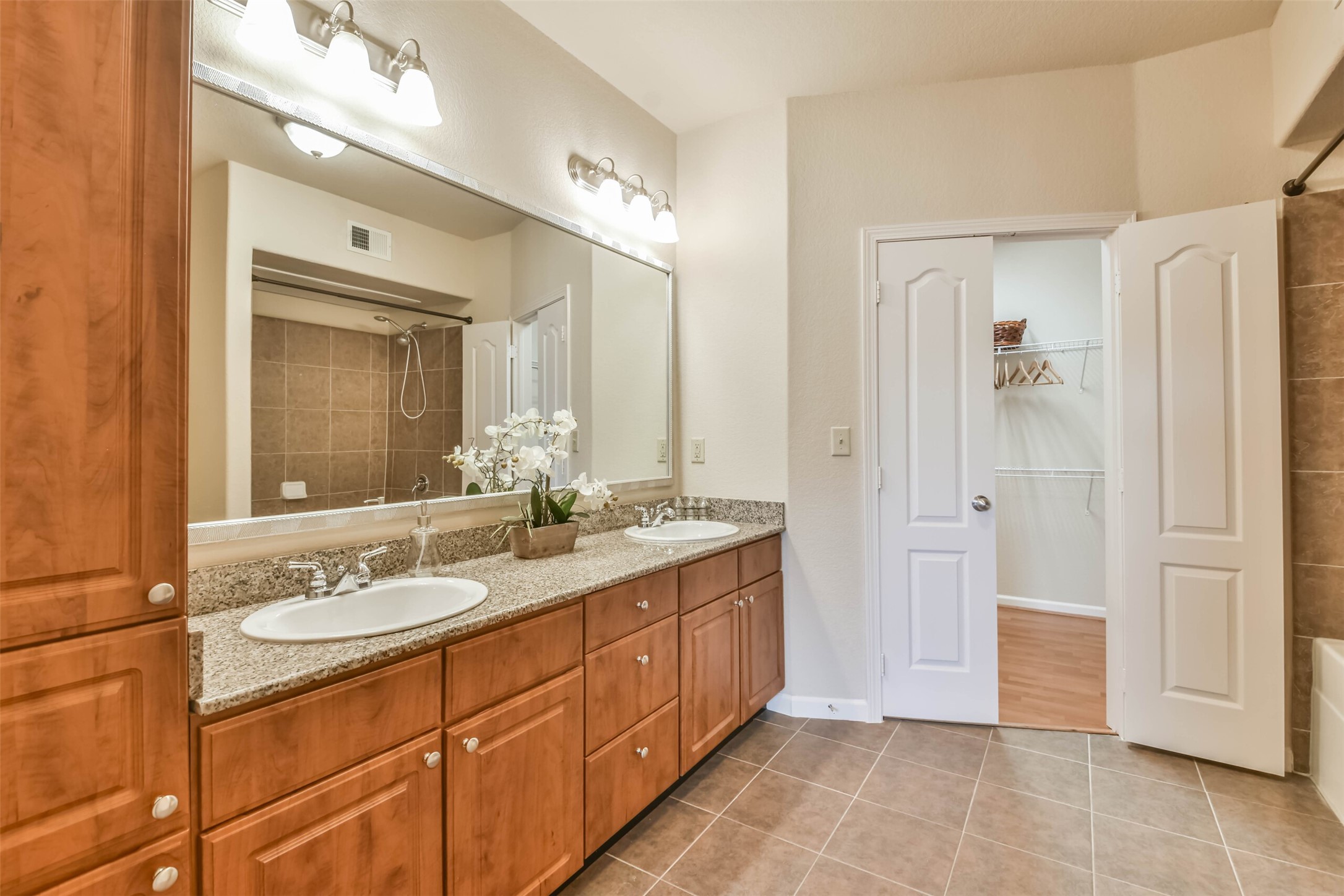 1711 Old Spanish Trail, Unit 406 Houston, TX 77054 - Photo 16 of 30 a spacious bathroom with a double vanity sink shower and a mirror