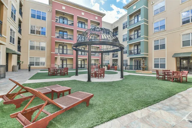 a front view of a building with a yard