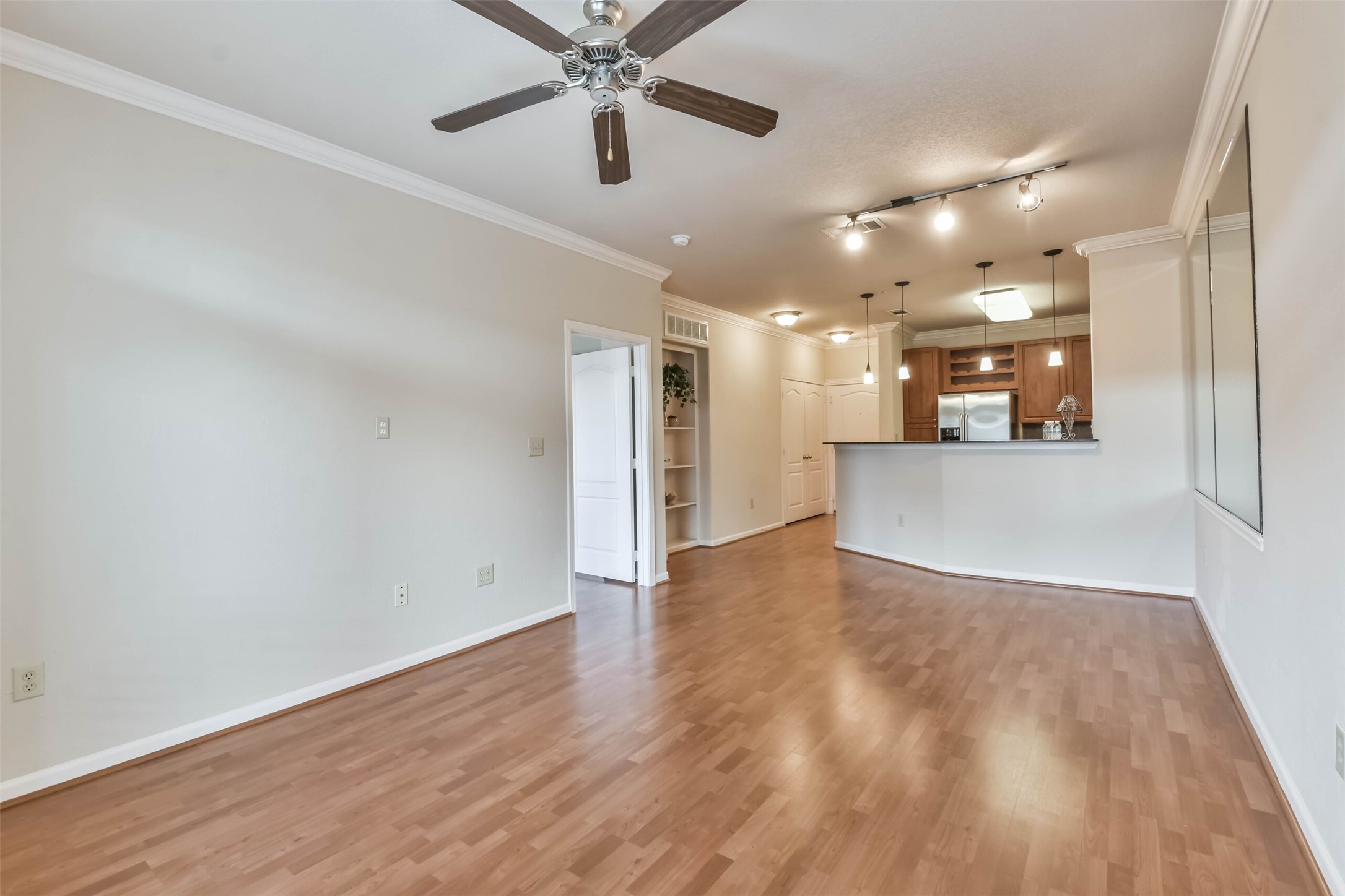 1711 Old Spanish Trail, Unit 406 Houston, TX 77054 - Photo 3 of 30 a view of a big room with wooden floor and a kitchen