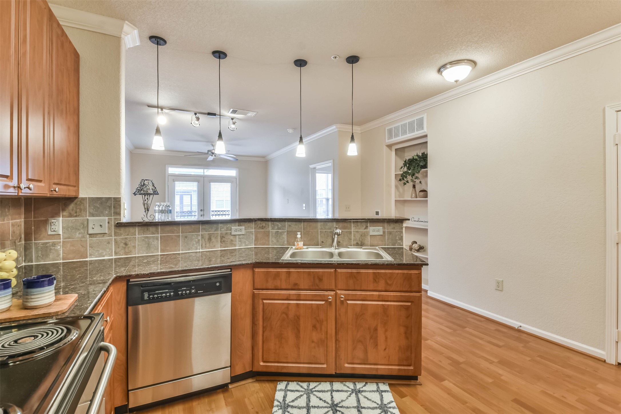 1711 Old Spanish Trail, Unit 406 Houston, TX 77054 - Photo 6 of 30 a kitchen with stainless steel appliances granite countertop a sink a stove and a wooden floors