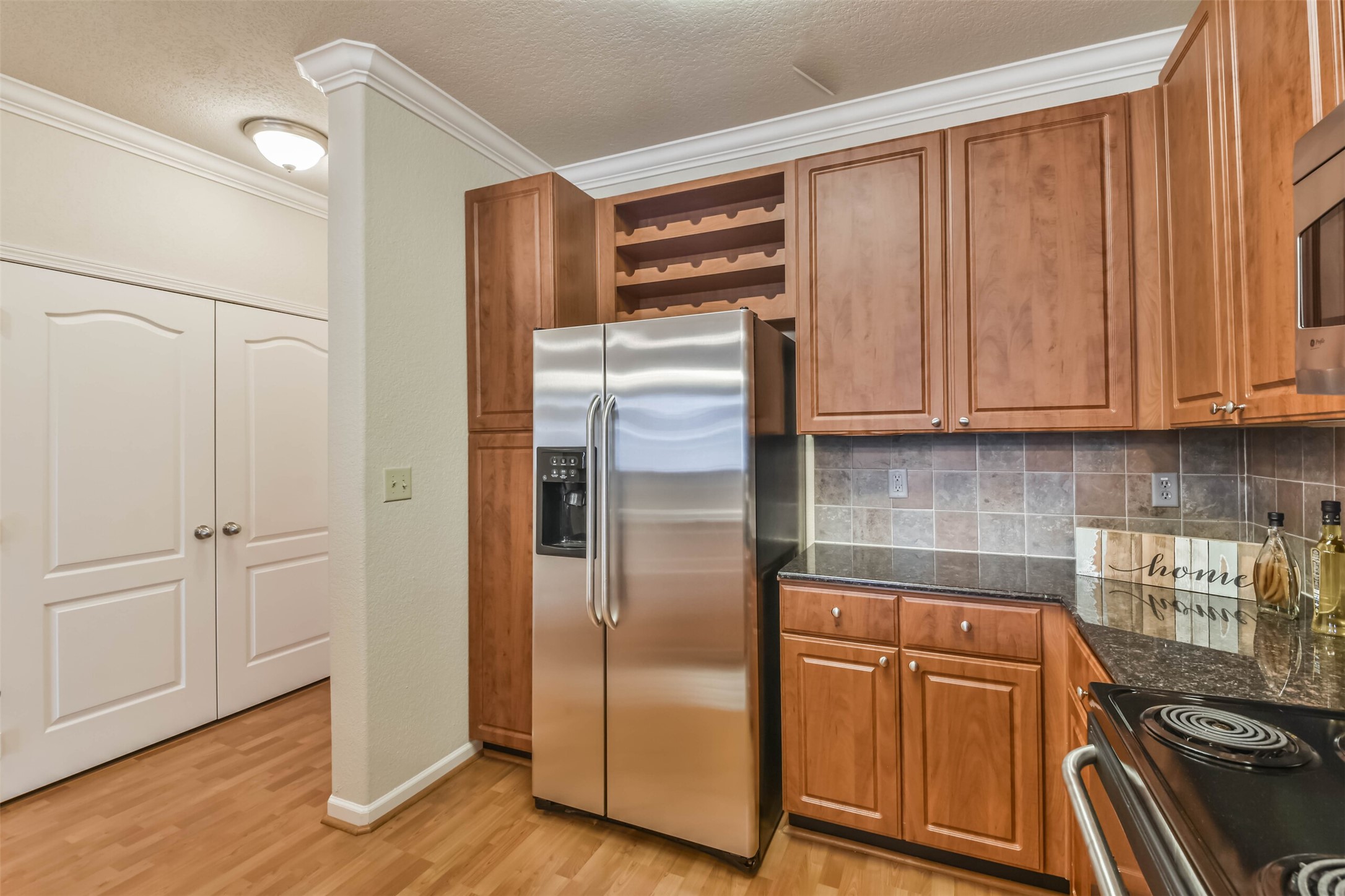 1711 Old Spanish Trail, Unit 406 Houston, TX 77054 - Photo 7 of 30 a kitchen with stainless steel appliances granite countertop a refrigerator and a stove top oven