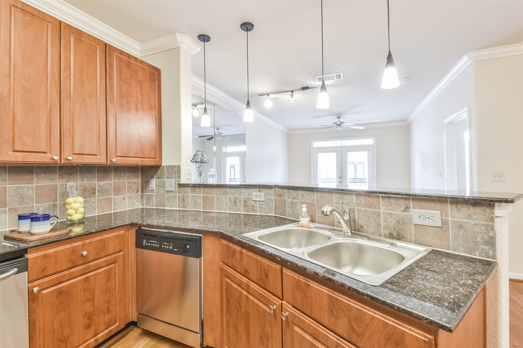 1711 Old Spanish Trail, Unit 406 Houston, TX 77054 - Photo 9 of 30 a kitchen with stainless steel appliances granite countertop a sink a counter space and cabinets