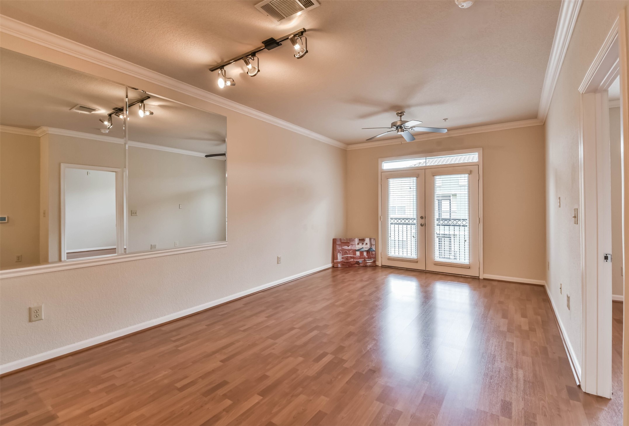 1711 Old Spanish Trail, Unit 406 Houston, TX 77054 - Photo 10 of 30 a view of an empty room with a window and wooden floor