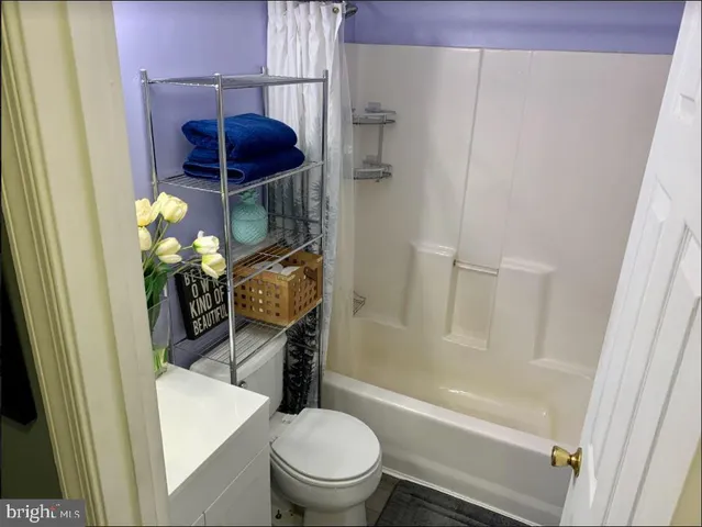 a bathroom with a toilet and a tub