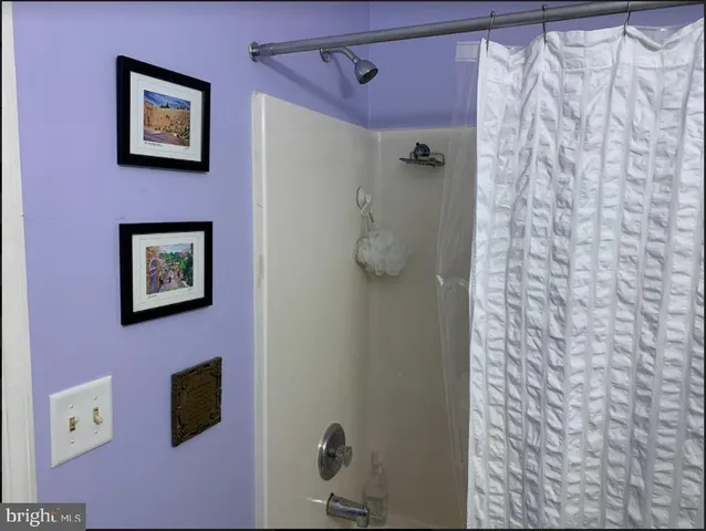 a bathroom with a shower and a shower