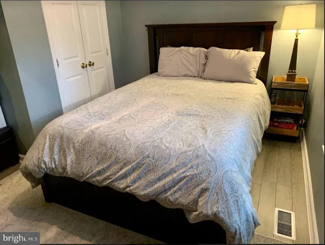 a bed sitting in a bedroom next to a window