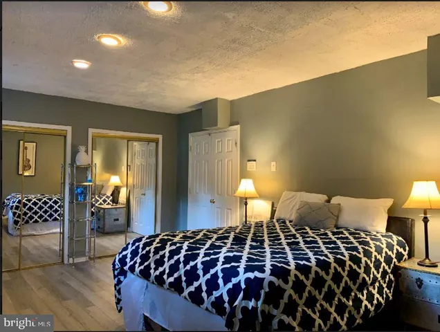 a bedroom with a bed and a lamp