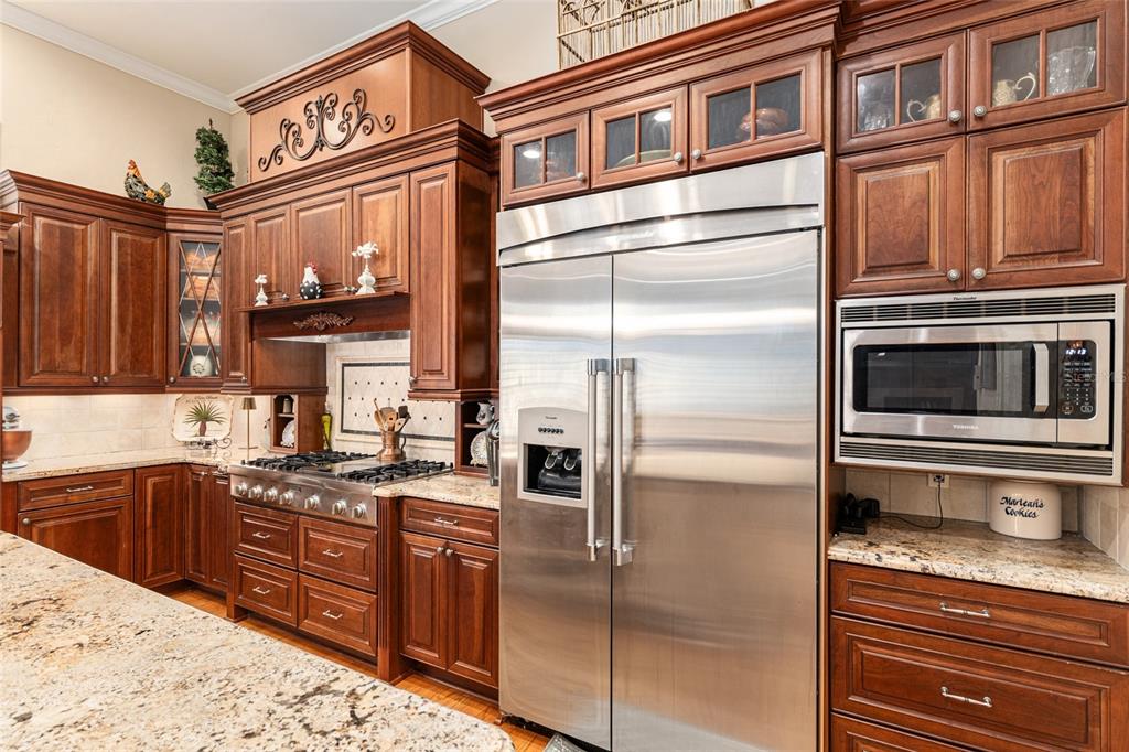 5015 Southwest 91 Terrace Gainesville, FL 32608 - Photo 23 of 61 a kitchen with stainless steel appliances granite countertop a refrigerator a stove and a sink with cabinets