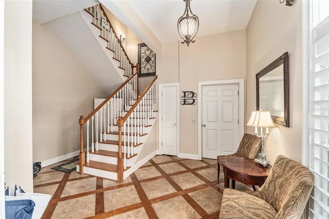 a living room with furniture kitchen view and a wooden floor