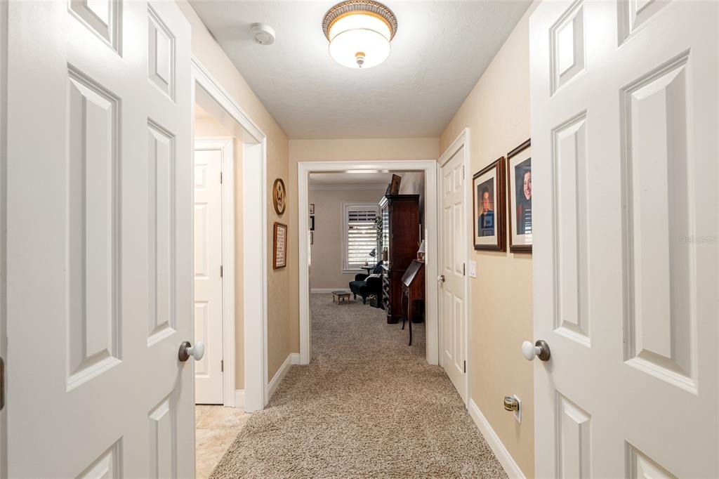 5015 Southwest 91 Terrace Gainesville, FL 32608 - Photo 39 of 61 a view of a hallway to a livingroom with wooden floor and windows