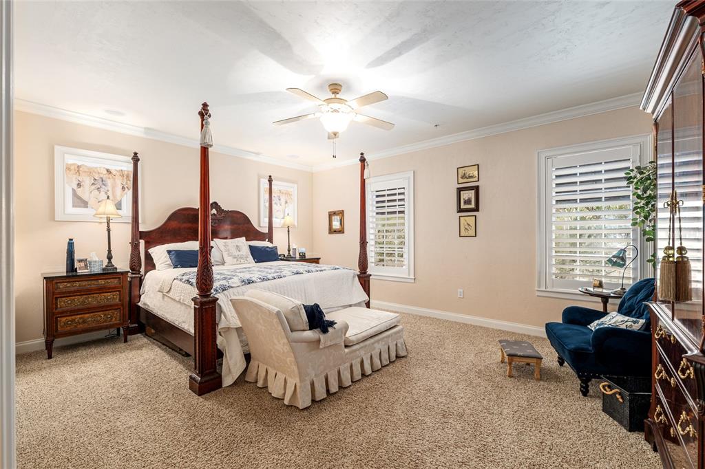 5015 Southwest 91 Terrace Gainesville, FL 32608 - Photo 40 of 61 a spacious bedroom with a bed and a couch